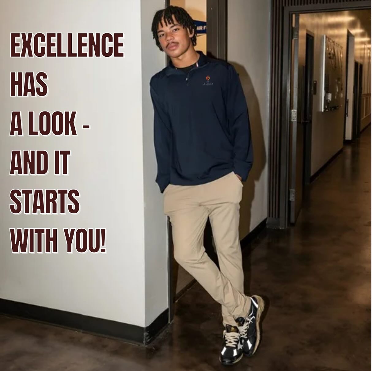 Legacy student modeling a navy pullover and khaki pants